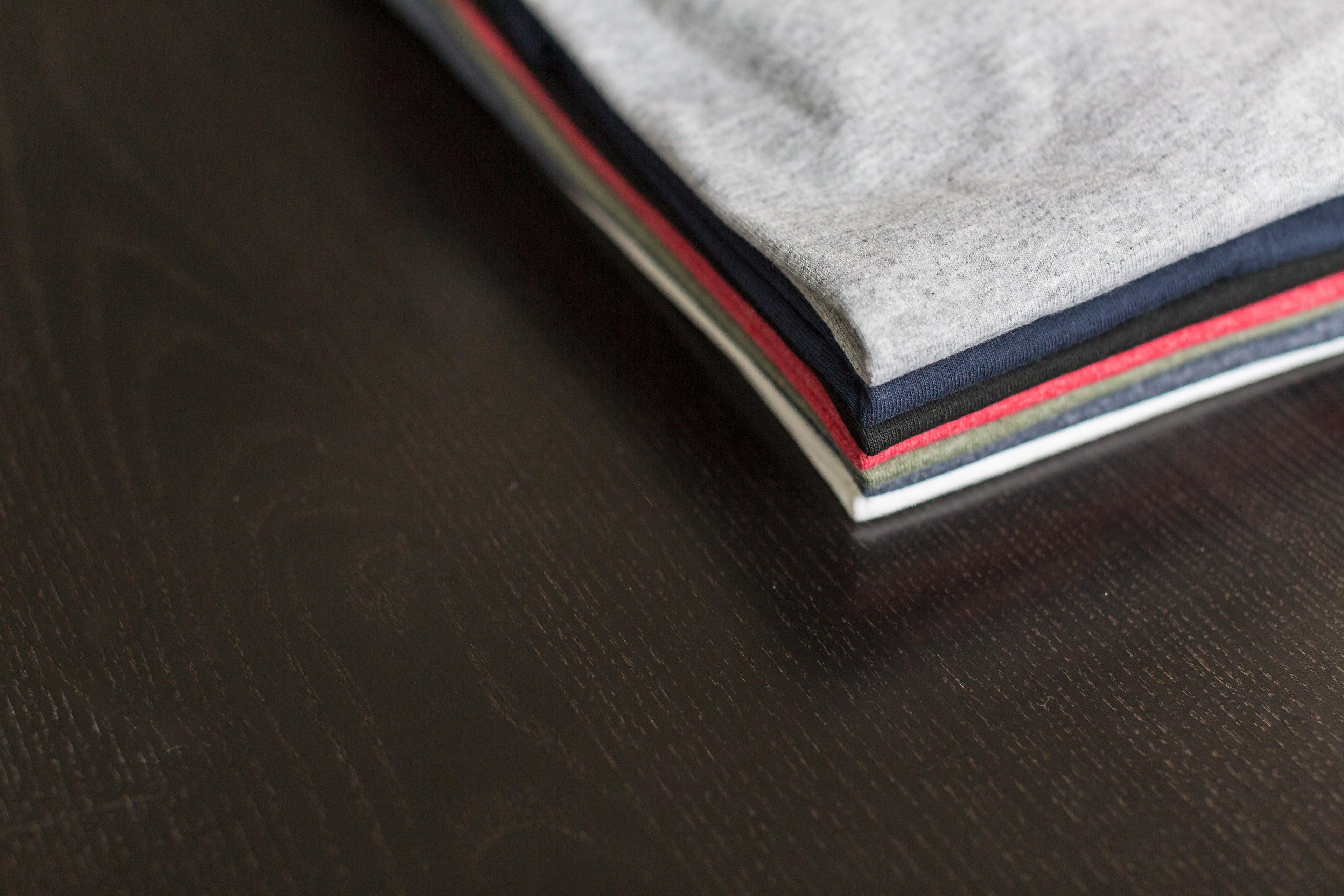 folded-tees-on-table - GoCart